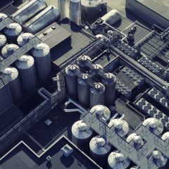 Aerial view of industrial buildings, tanks and pipes of a brewery.